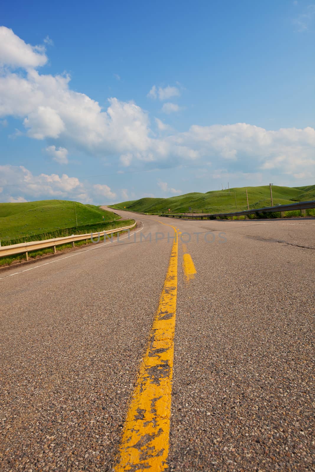 A rural, single lane highway winding uphill.  Canadian landscape.