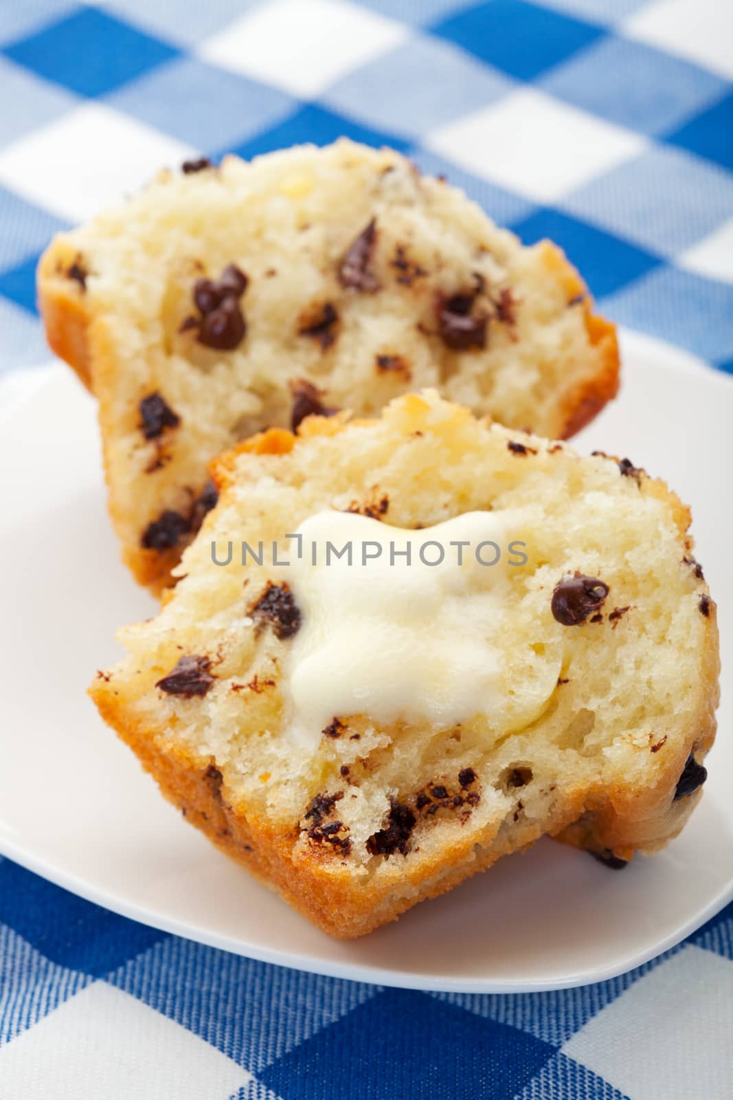 A warm, freshly baked, chocolate chip muffin, with melting butter.