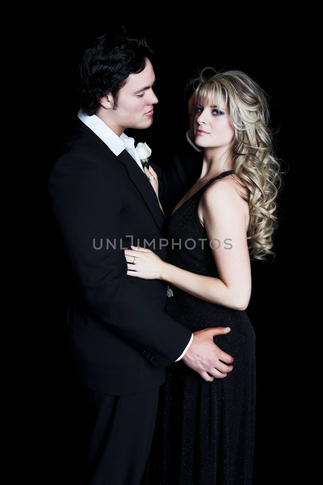 A romantic, young couple dressed in formal evening wear. 