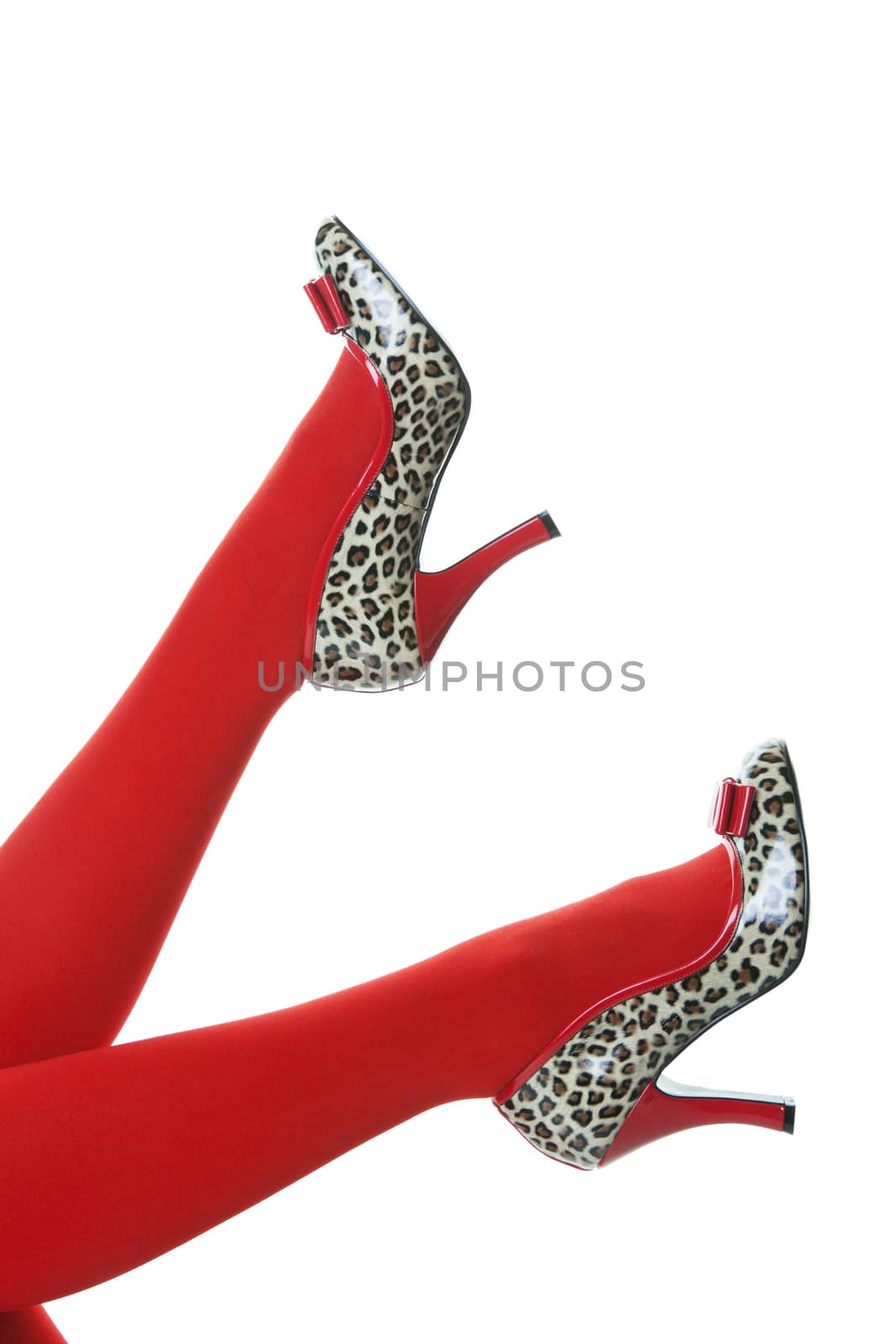 Beautiful red stockings, with red and animal print, rockabilly style high heels kicking up into the air.  Shot on white background.