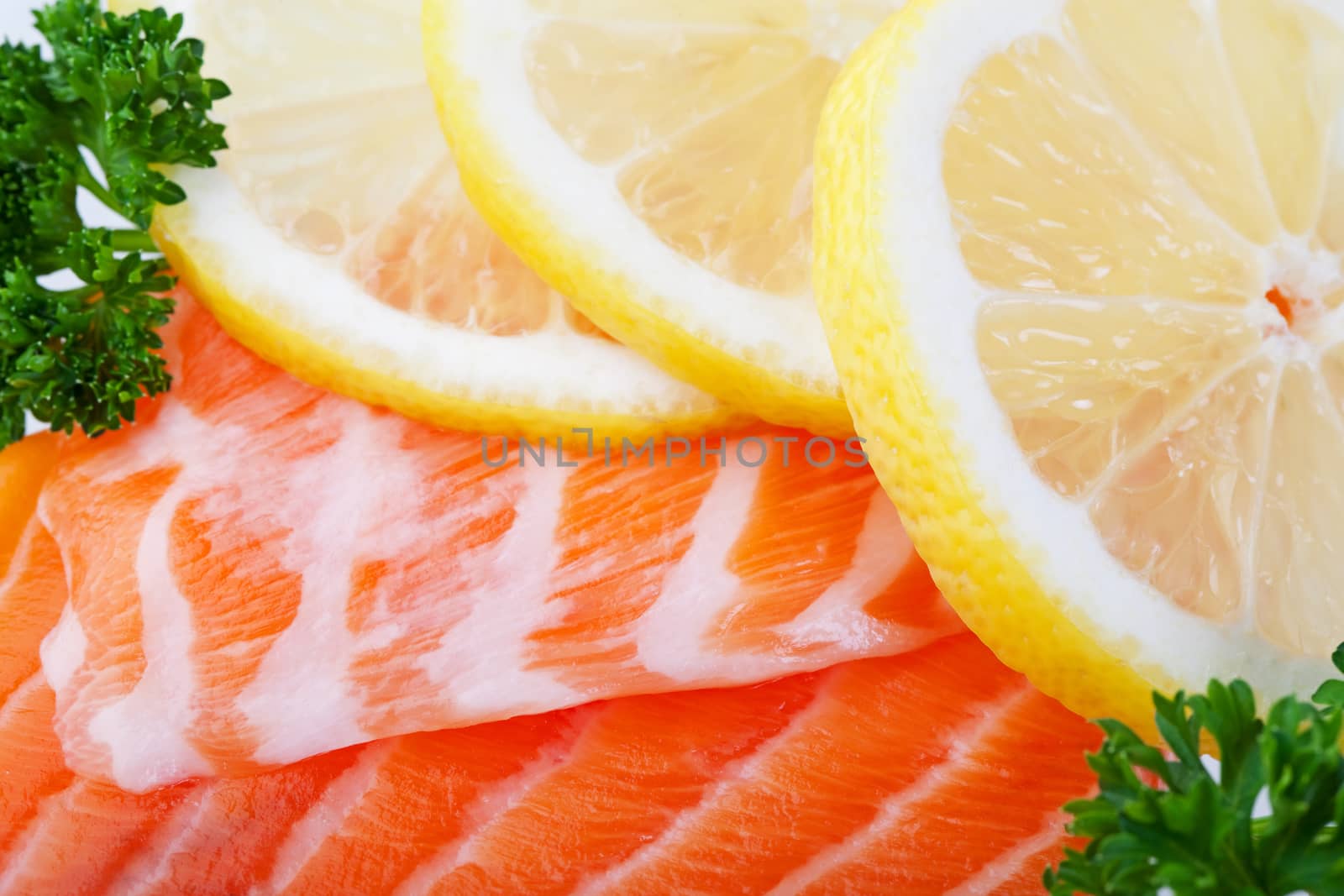 Fillets of fresh salmon with lemon slices  on ice.  Macro.