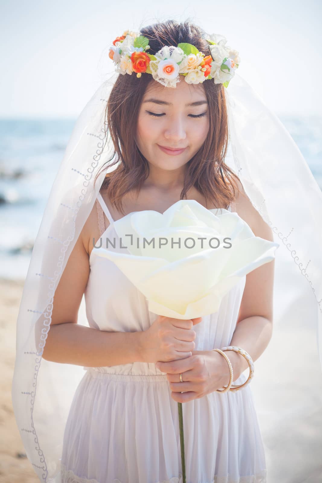 Beautiful young woman on the beach by witthaya