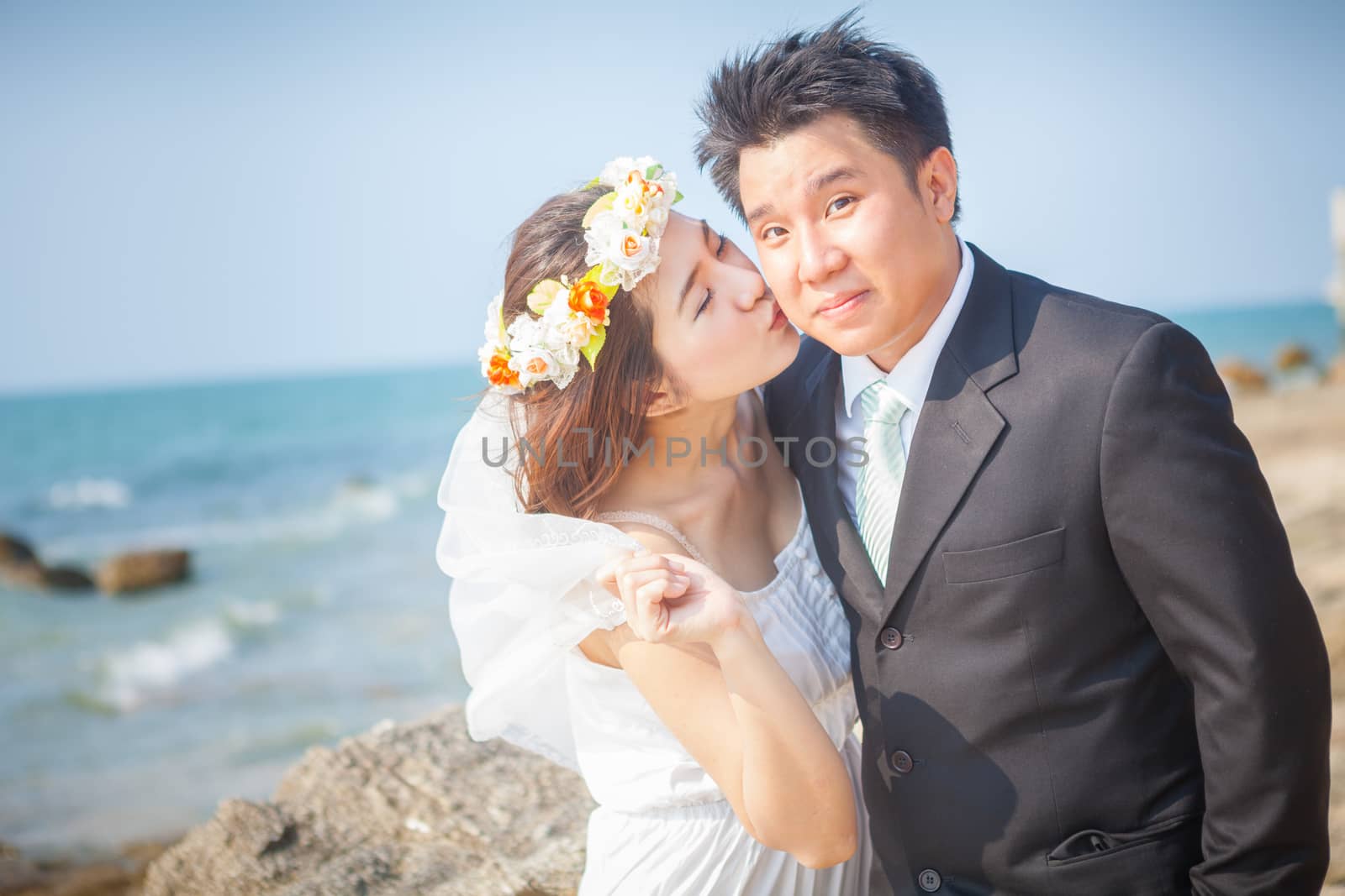 Happy young asian couple in love outdoor on the beach