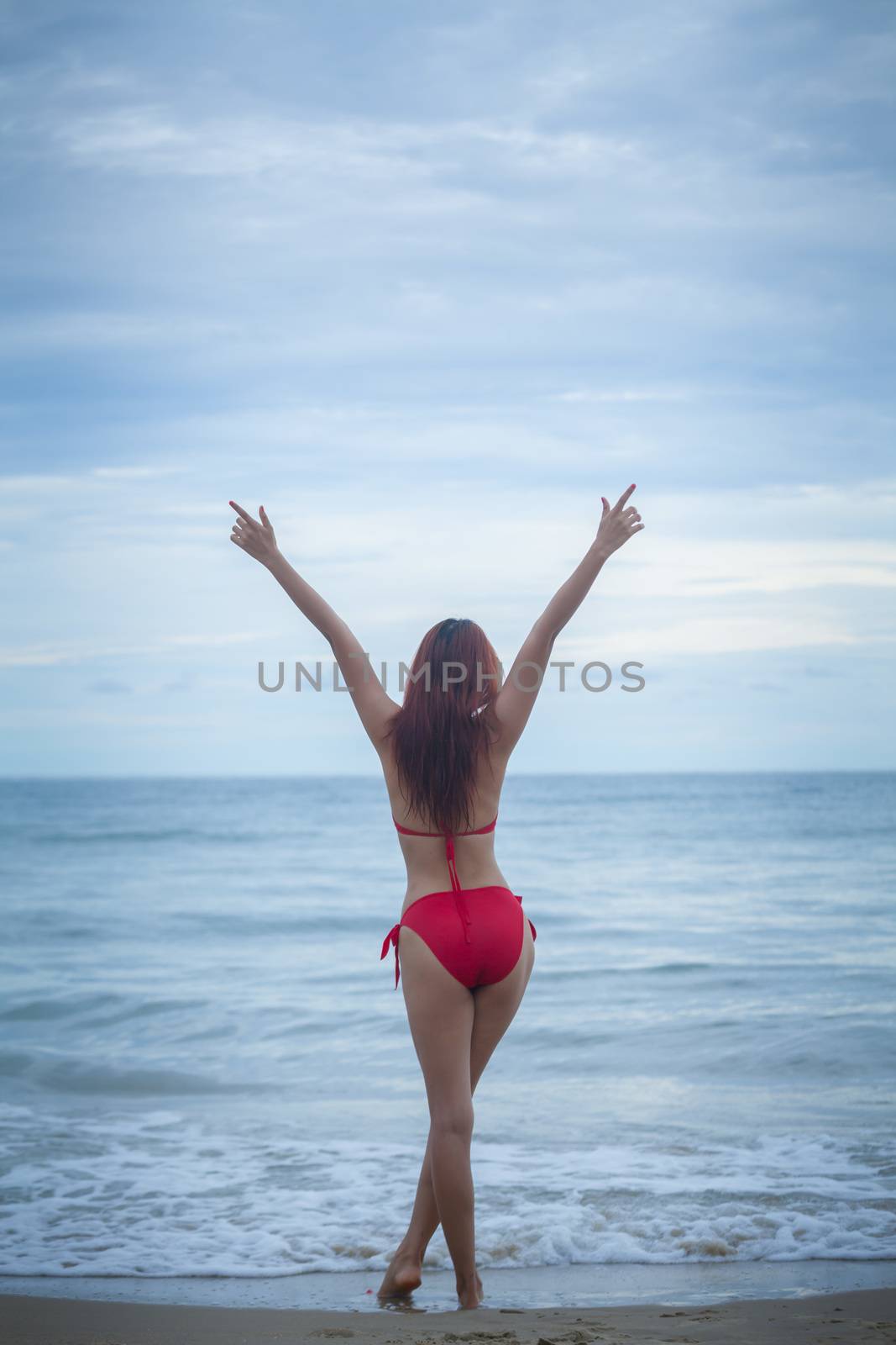 Woman posing at beach by witthaya