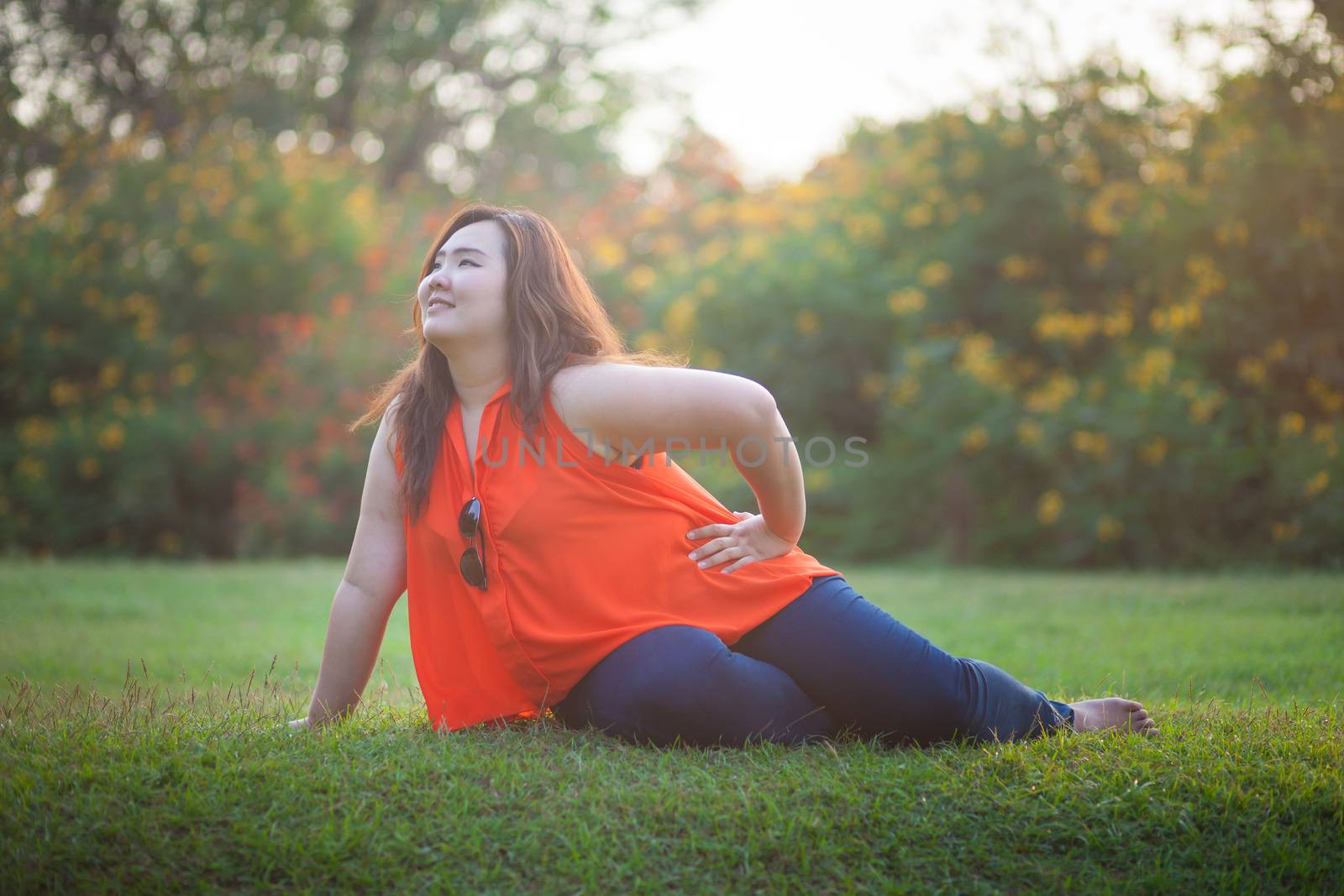 Happy fatty asian woman posing outdoor in a park