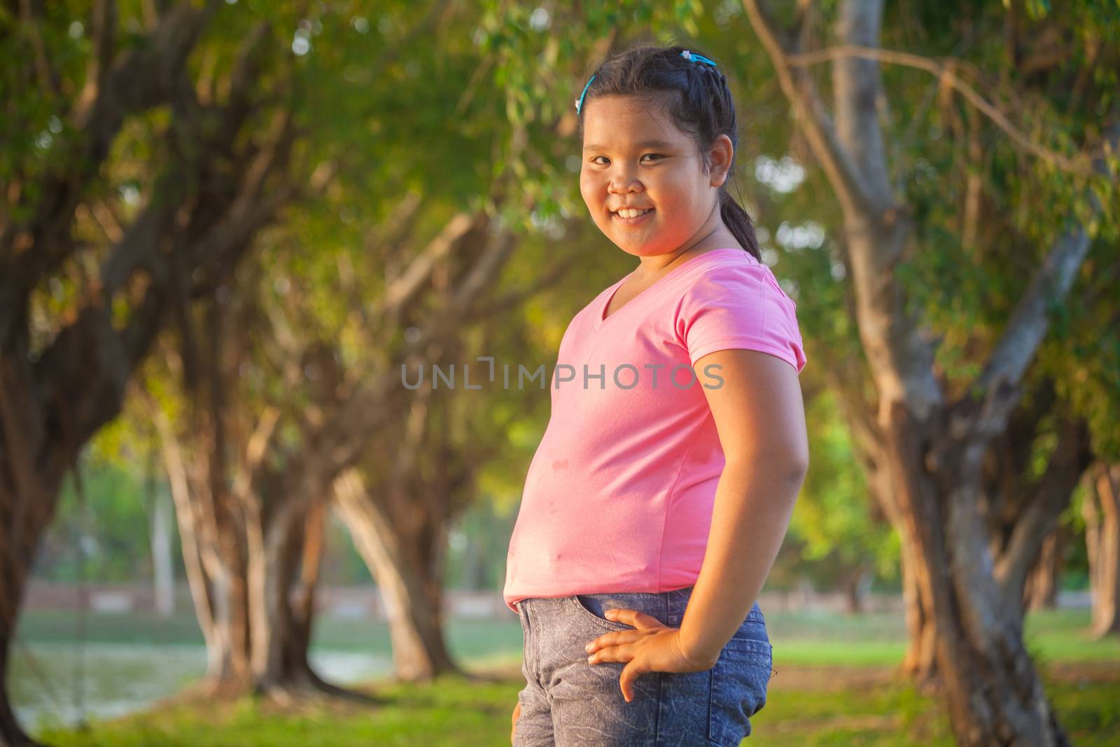 Portrait asian fat girl in the park on sunset