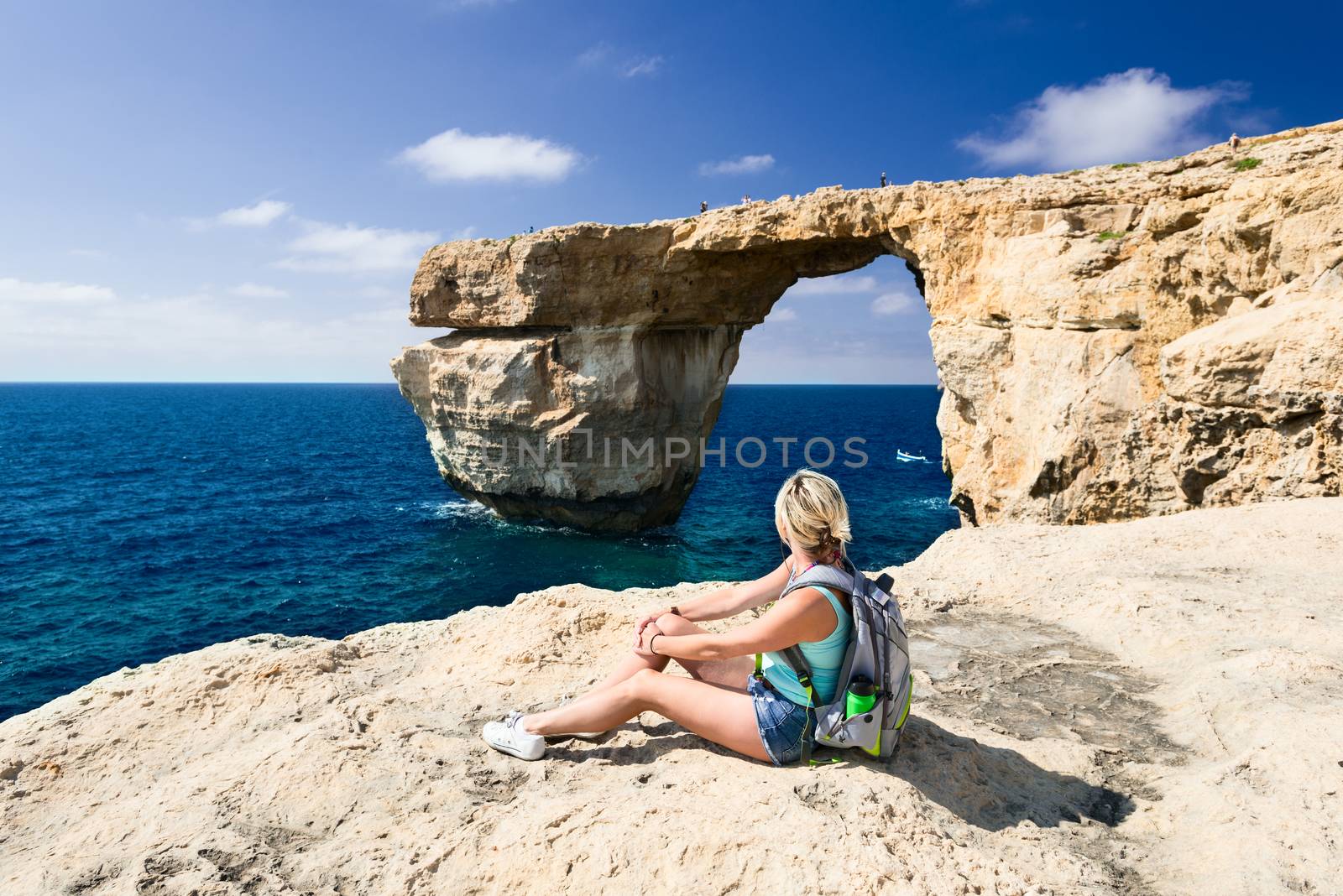 Girl looking on Azure Window on Gozo Island by Nanisimova