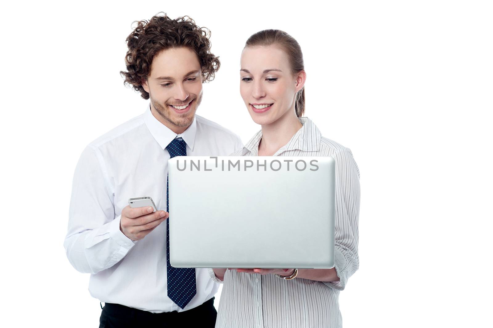 Happy business people  browsing on a laptop by stockyimages