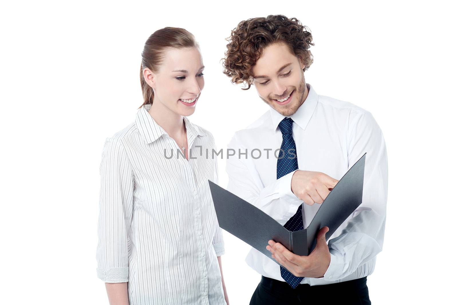 Businessman and woman looking at folder by stockyimages