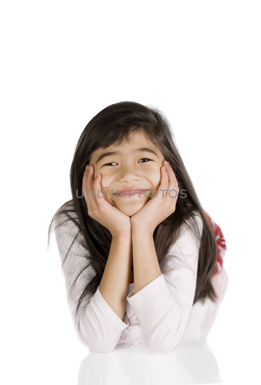 Little biracial Asian girl resting on floor, head on hand