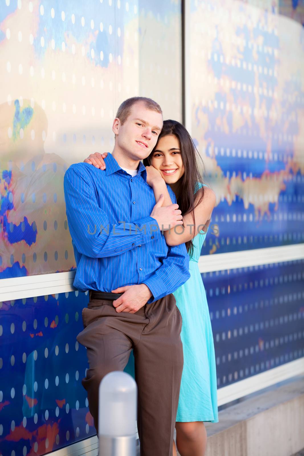 Happy interracial couple standing together outdoors