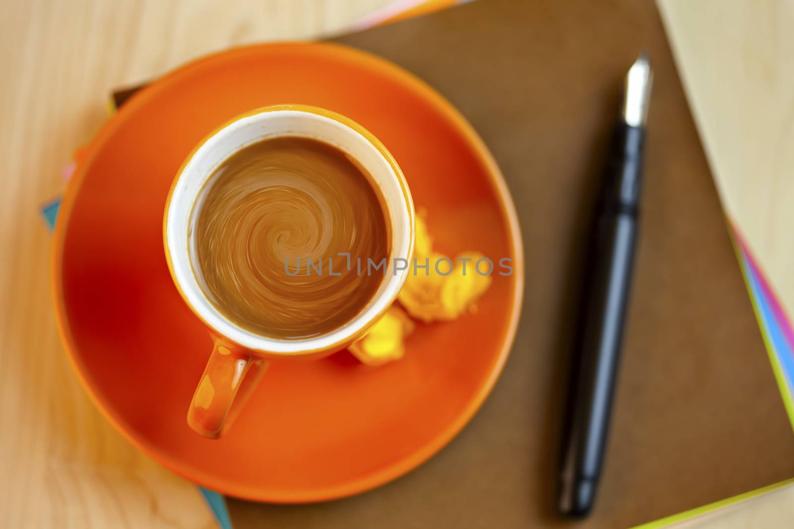 Orange coffee cup on brown writing paper with pen by jarenwicklund