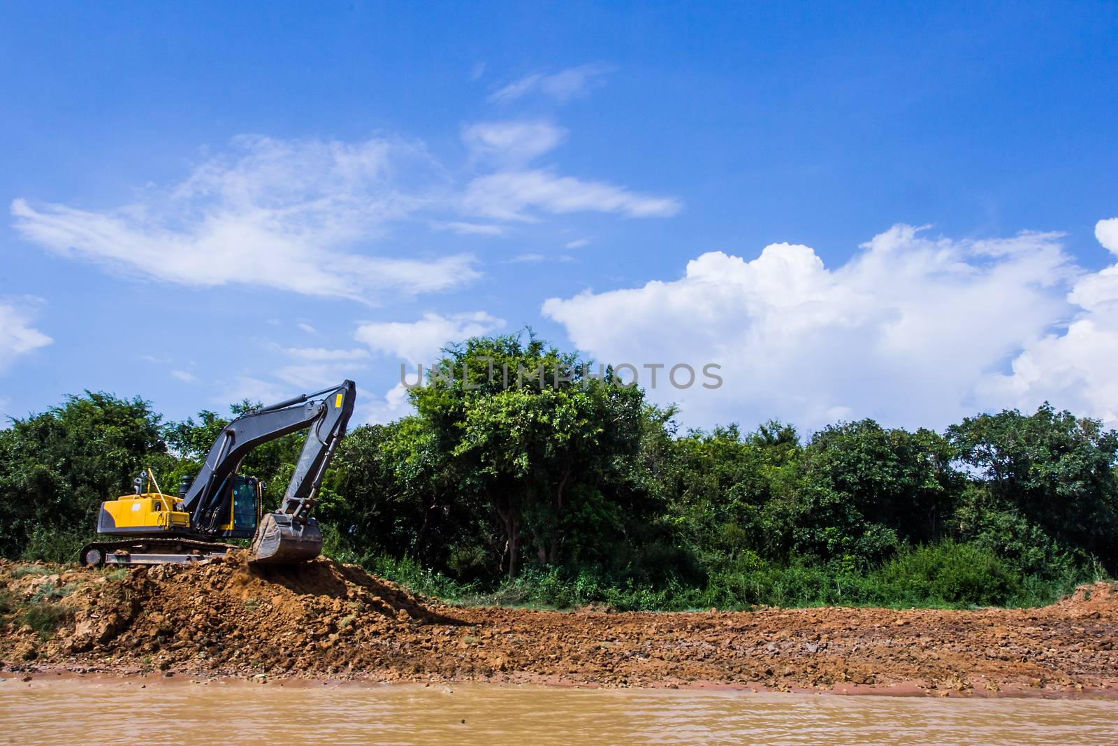 Excavator loading dumper truck tipper in construction site