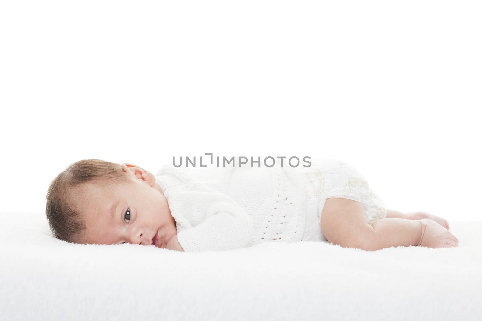 A mixed race newborn baby boy staring at the camera.  Shot on white background.