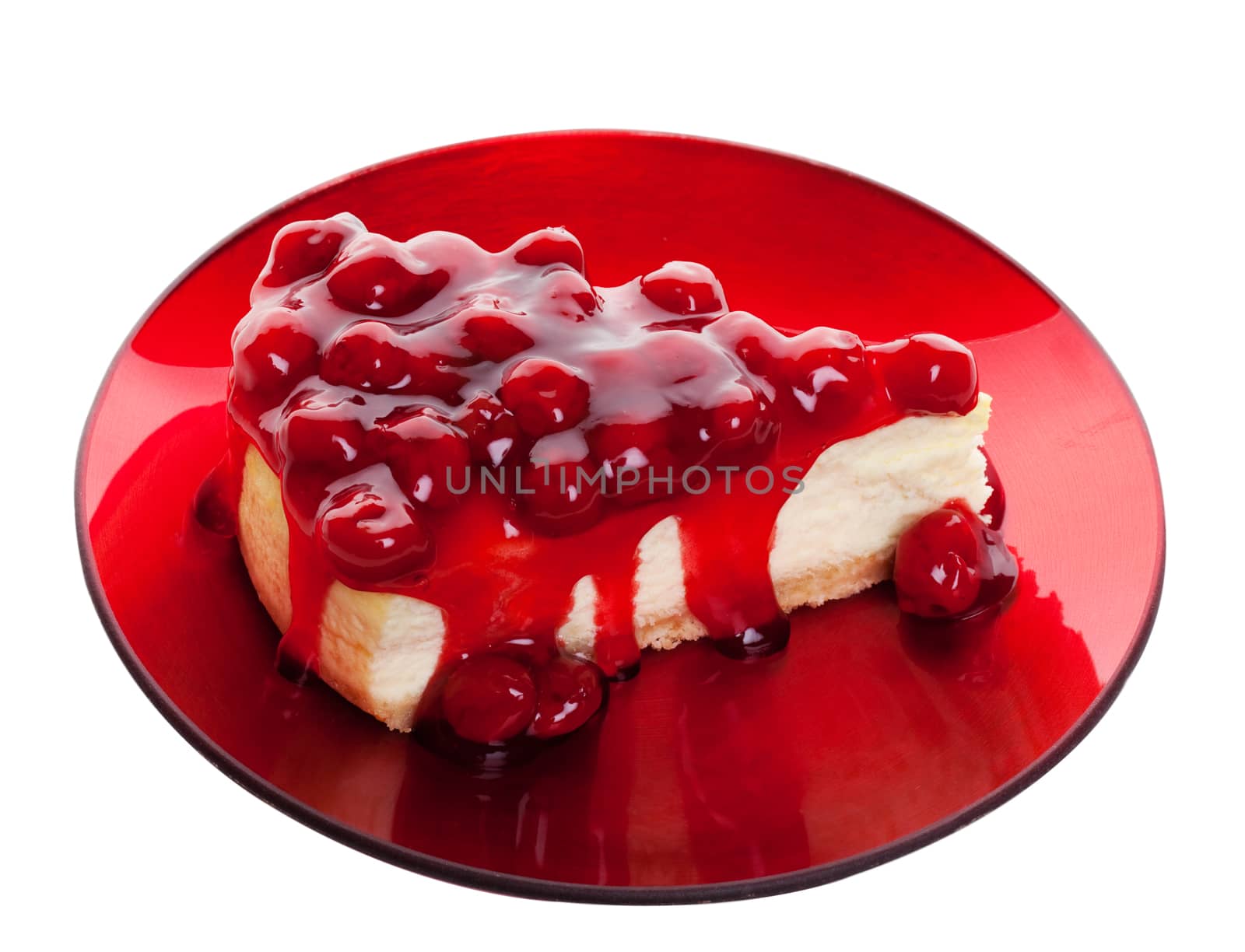 Decadent cherry cheesecake served on a candy apple red plate.  Shot on white background.