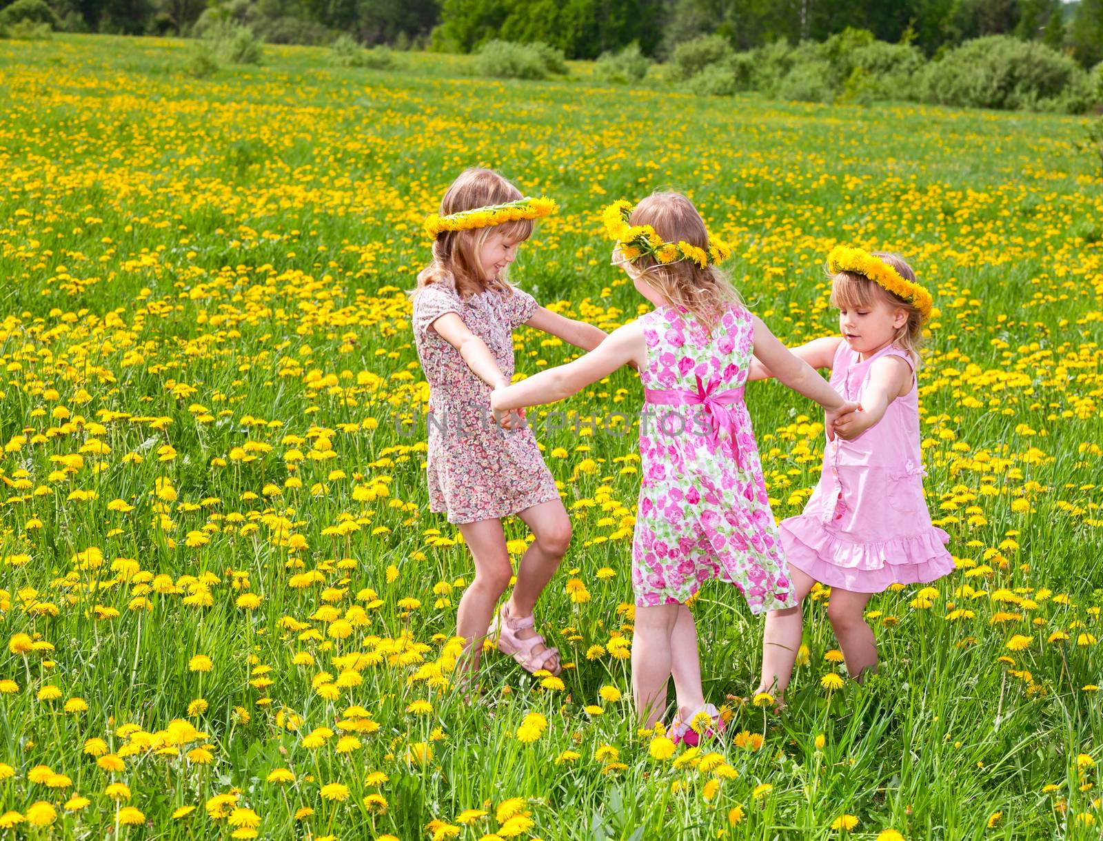 Children playing on a dandelion field by naumoid
