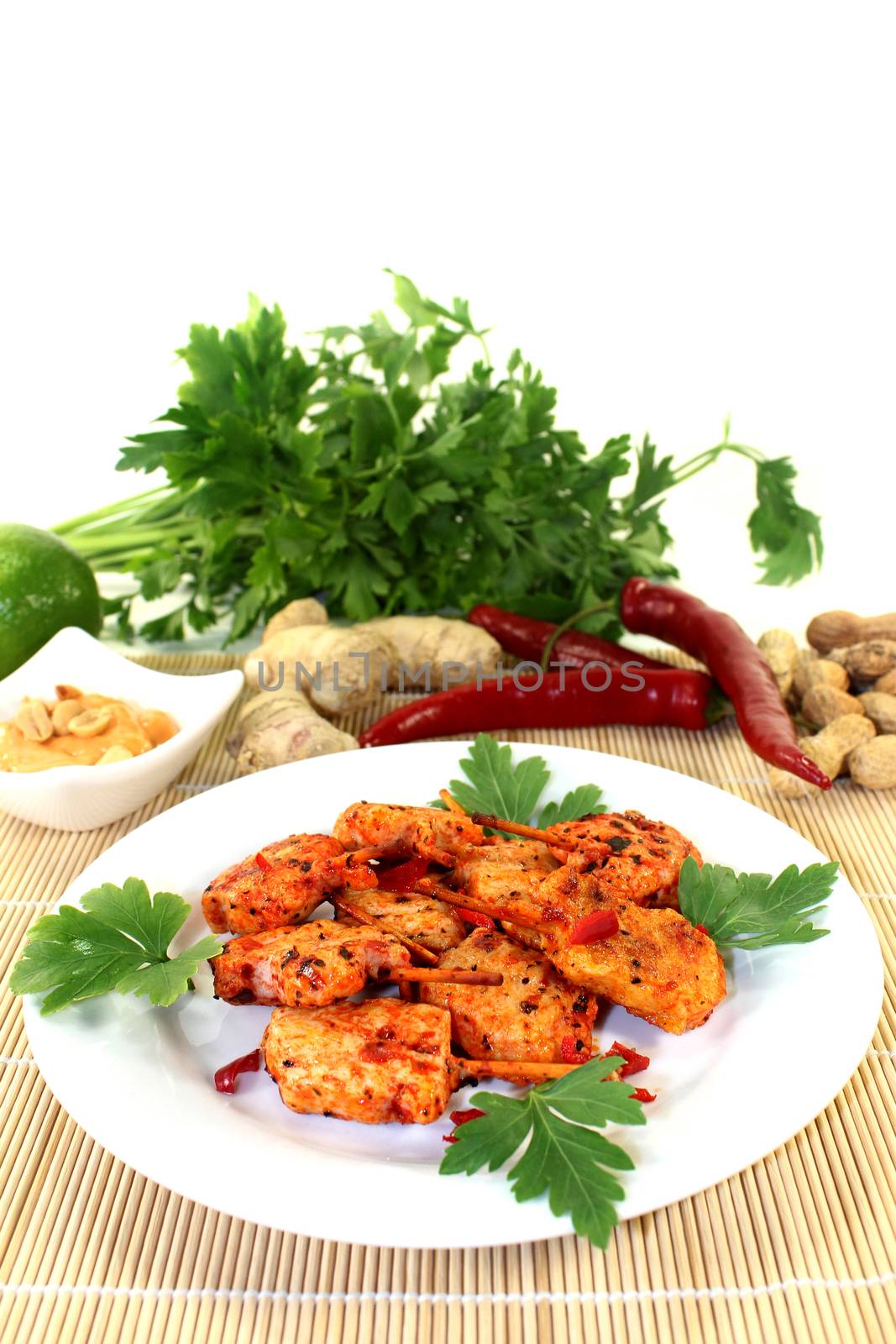 Skewer with hot peppers on a white plate