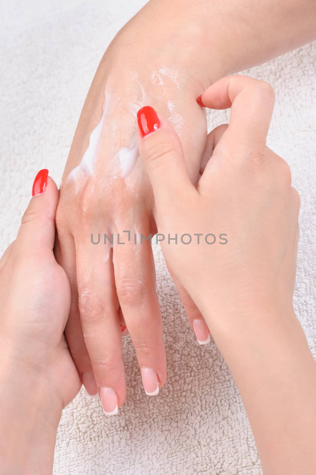 beauty salon, manicure and hands skin care - cream applying