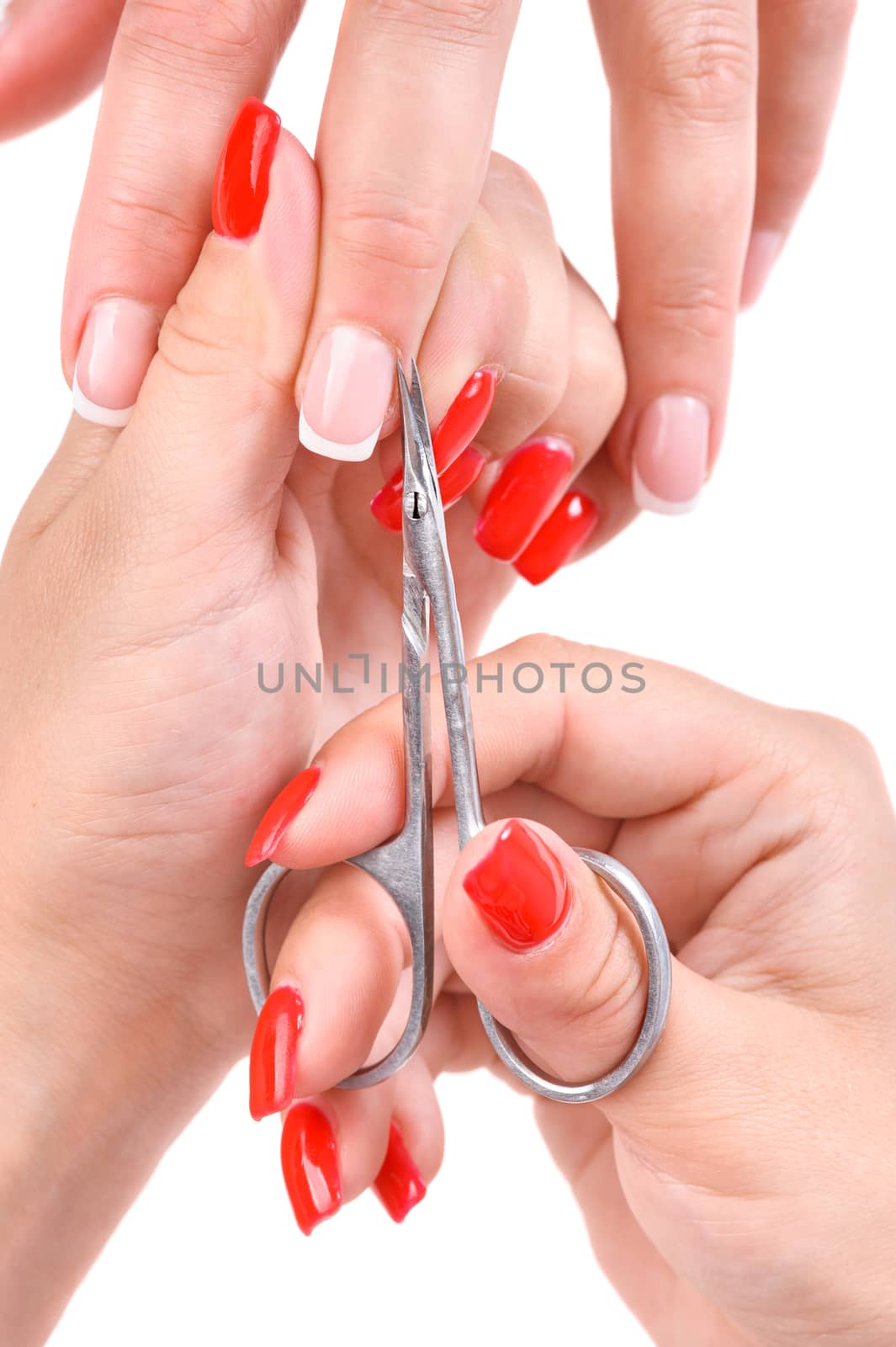 beauty salon, manicure applying, cutting the cuticle with scissors