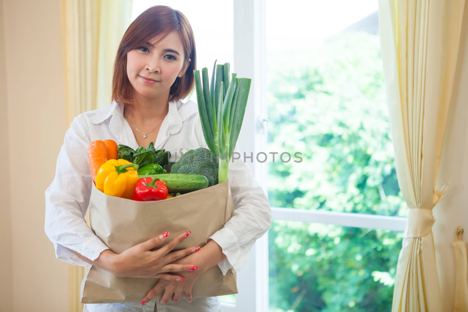 Happy Young Asian Woman with vegetables in shopping bag