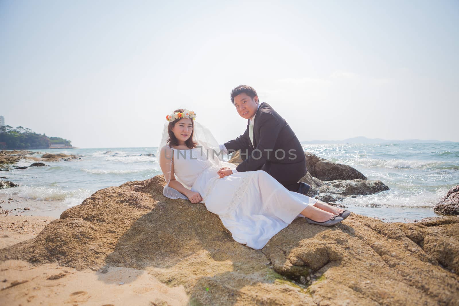Happy young asian couple in love outdoor on the beach