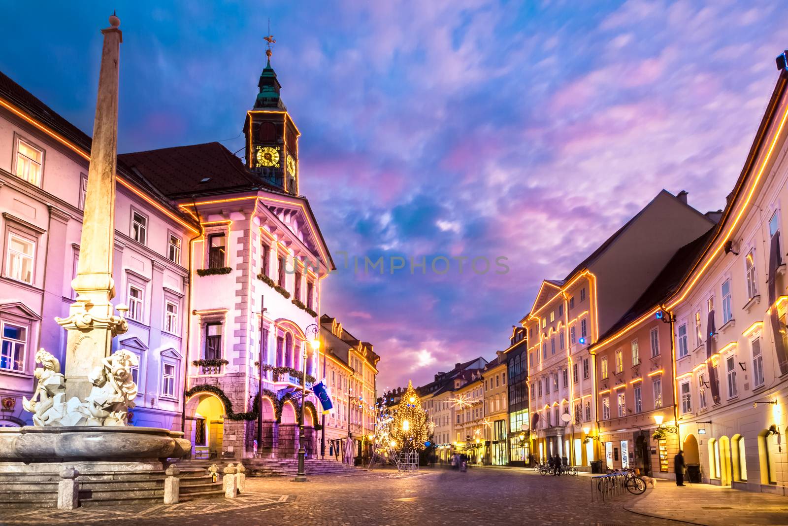 Romantic Ljubljana's city center, the capital of Slovenia, Europe. City hall and Roba's fountain shot at dusk.