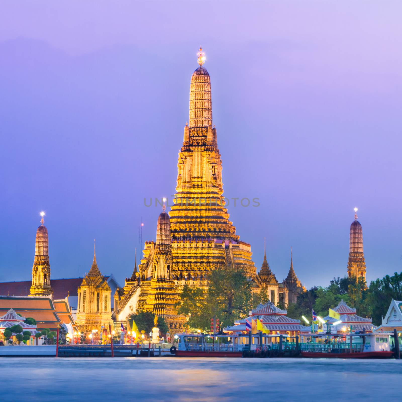 Wat Arun, The Temple of Dawn, at twilight, view across  Chao Phraya river. Bangkok, Thailand.