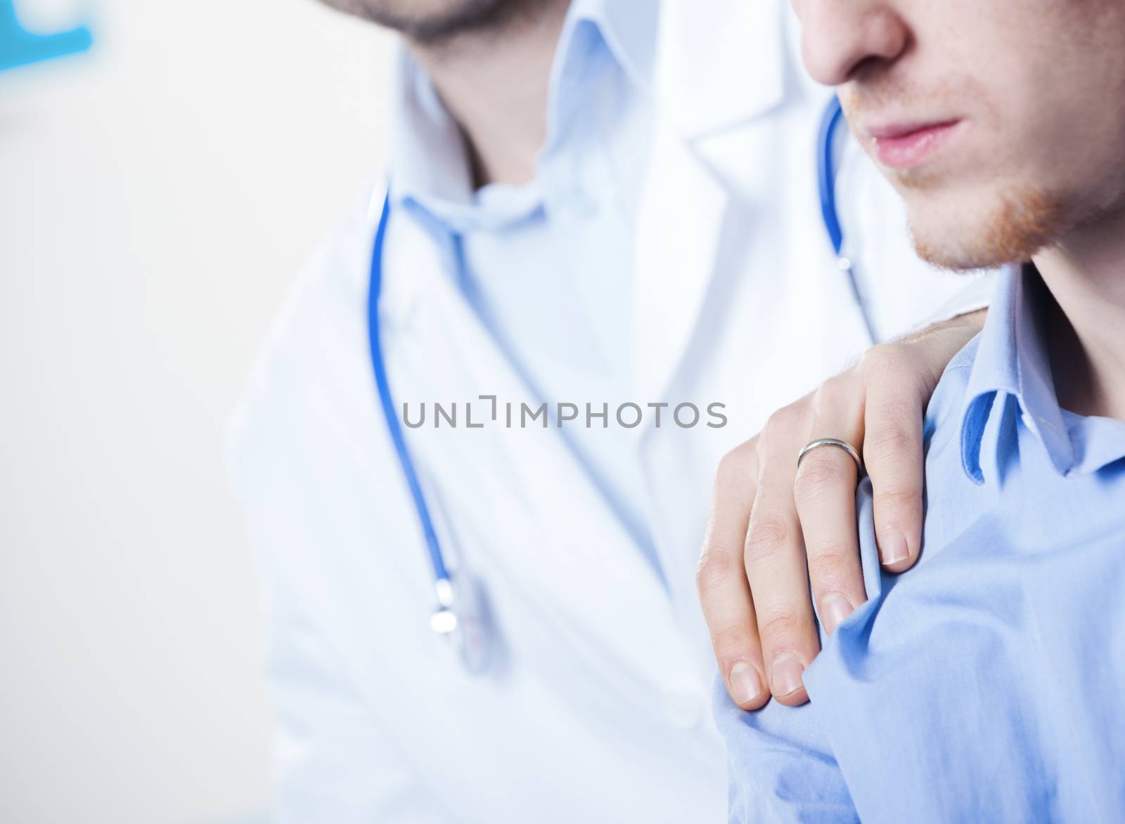 Doctor comforting a young patient after telling him bad news.