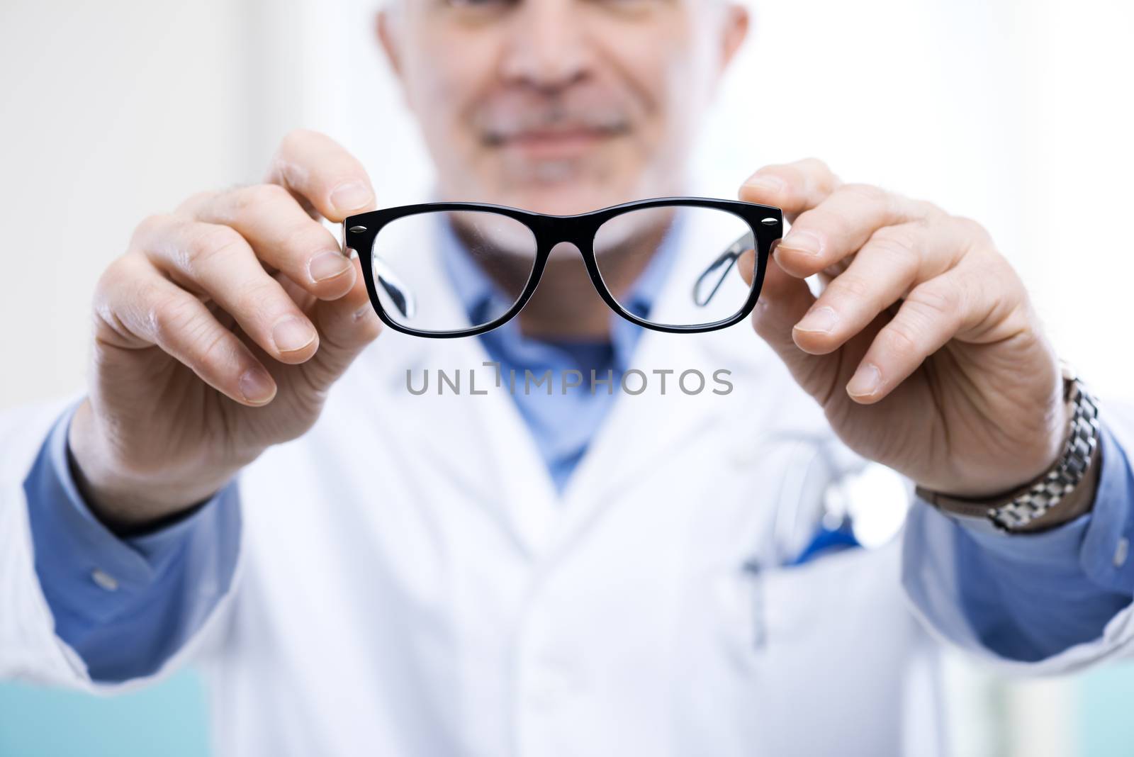 Oculist giving a pair of glasses during a visit.