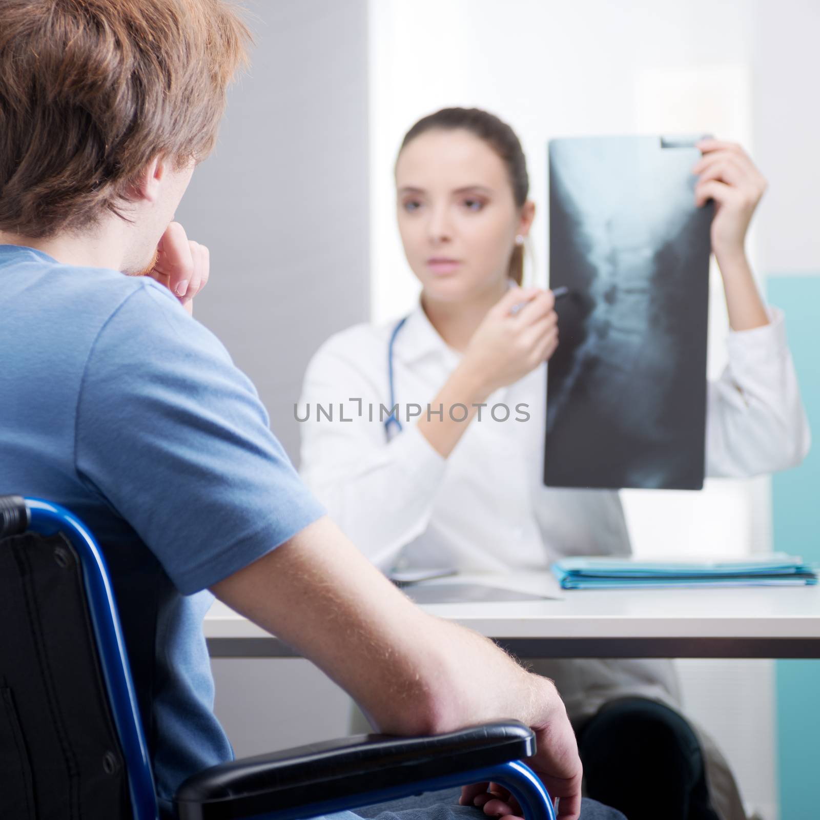 Young patient with female doctor discussing x-ray