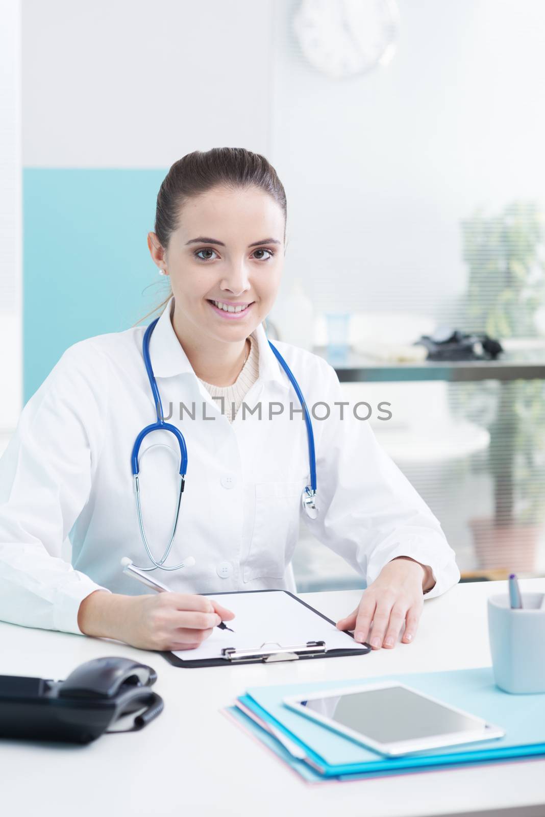 Smiling woman doctor or pharmacist in office 