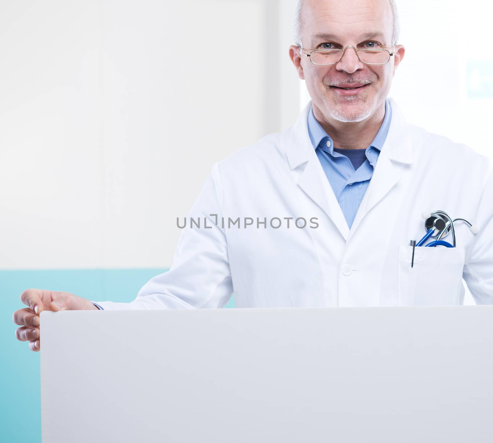 Doctor holding a big white sign with blank copy space.