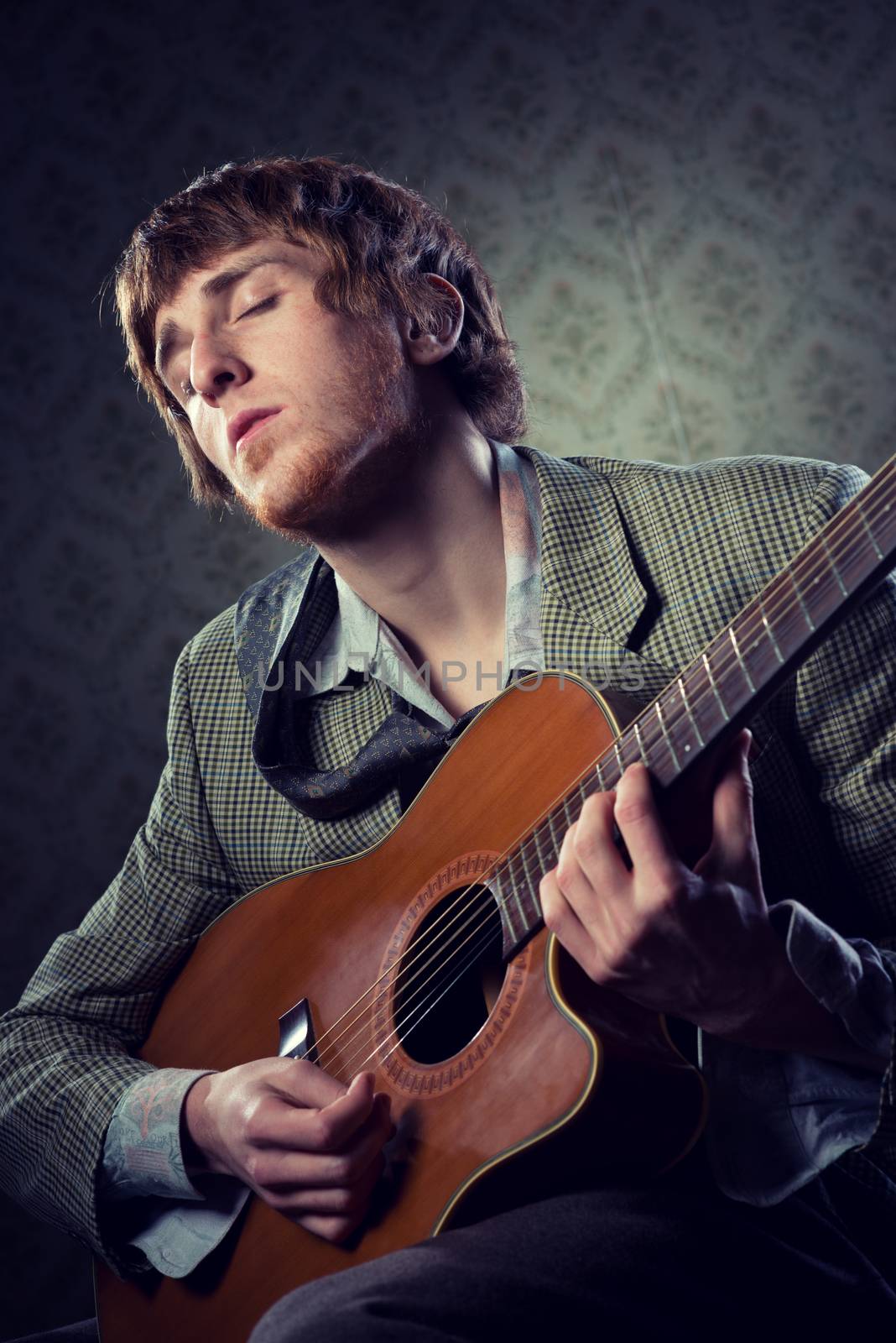 Vintage guy playing acoustic guitar and singing on retro wallpaper.