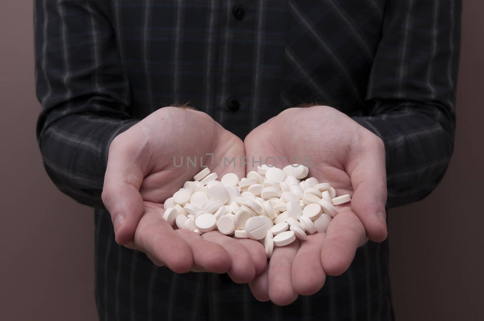 Caucasian Man Holding a Bunch of Pills and Capsules / Capsules and Pills / Medicine