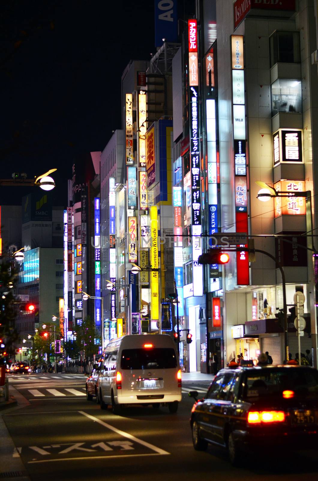 Tokyo, Japan - November 23, 2013: Neon lights in Shinjuku district by siraanamwong