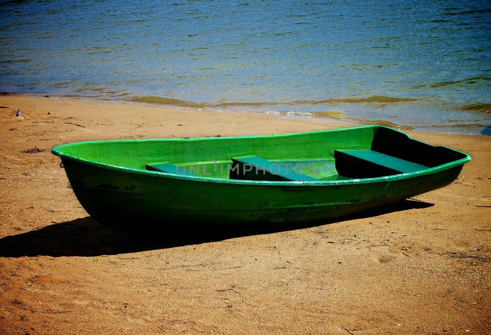 Old Lonely Green Boat on Sand River Shore Outdoors