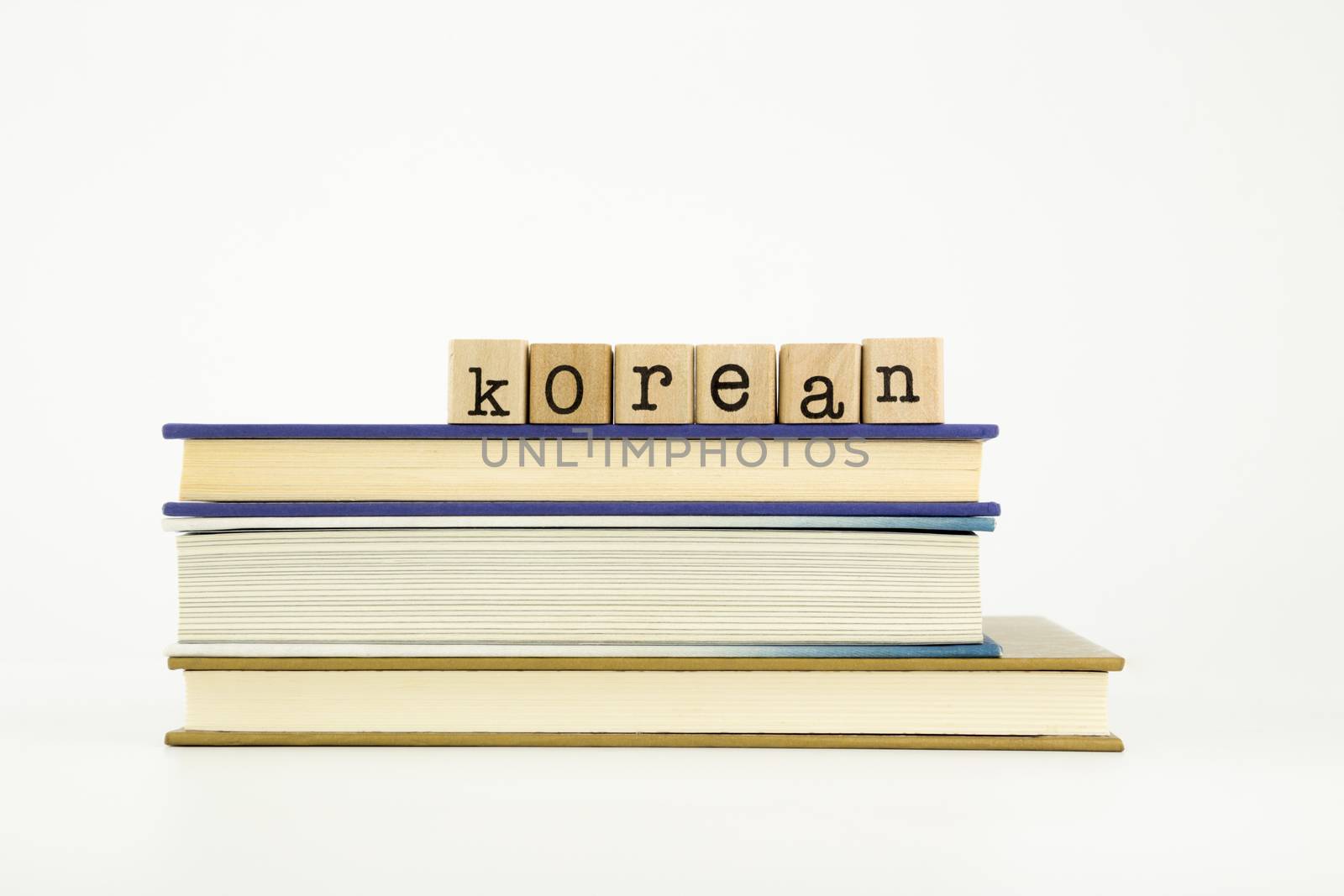 korean word on wood stamps stack on books, language and education concept