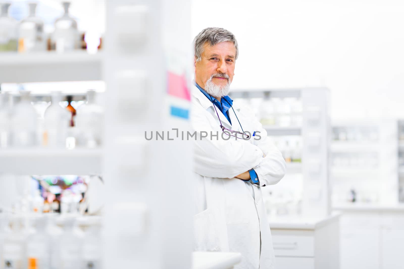 Senior male researcher carrying out scientific research in a lab (shallow DOF; color toned image)