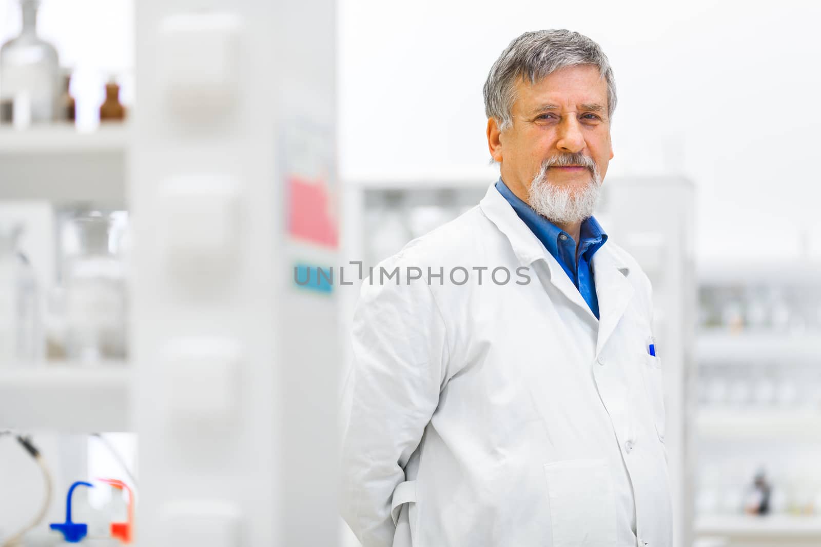 Senior male researcher carrying out scientific research in a lab (shallow DOF; color toned image)