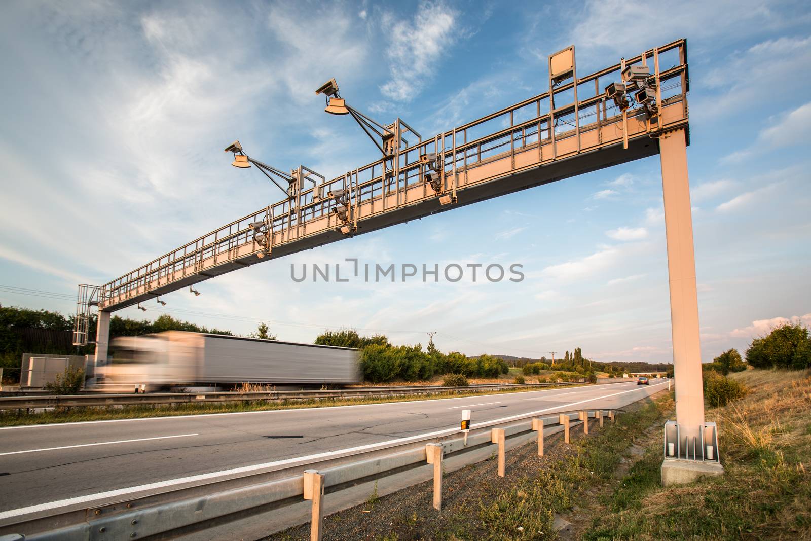 Truck passing through a toll gate on a highway by viktor_cap
