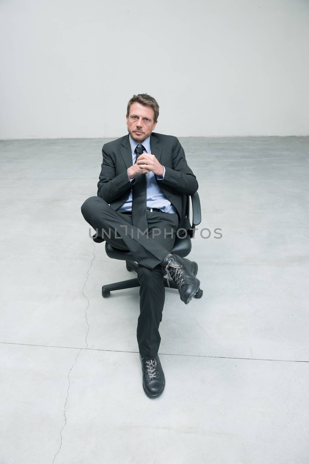 Businessman sitting on an office chair by stokkete