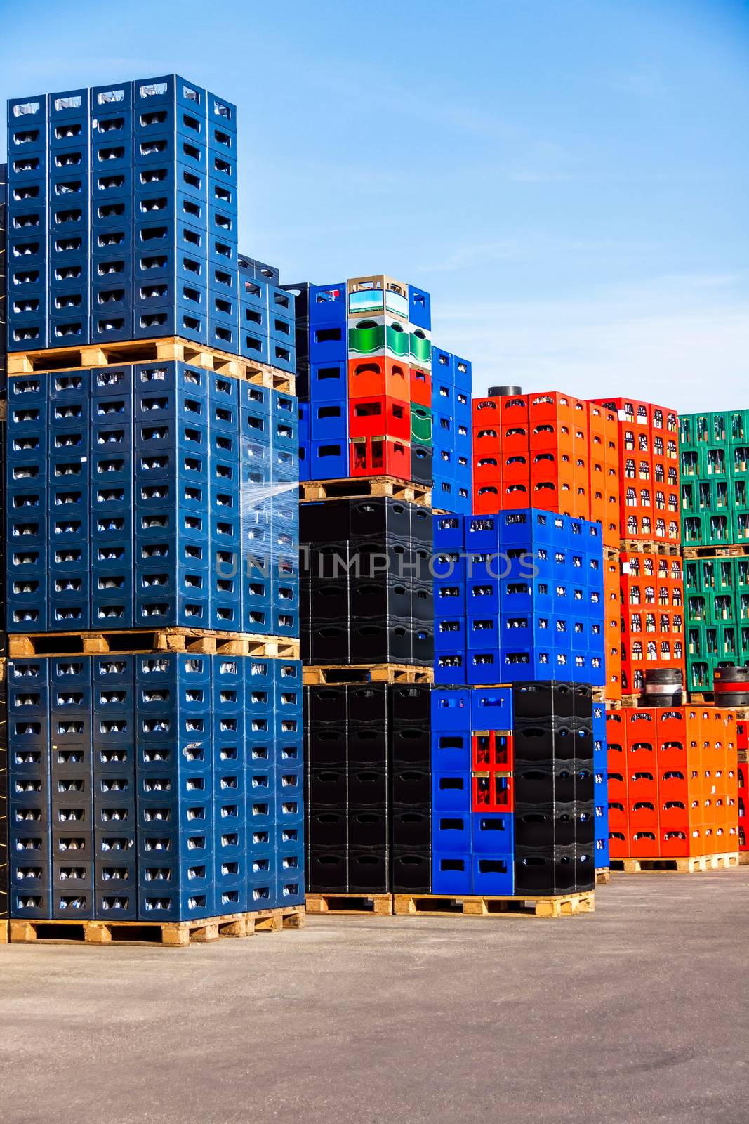 Several stacks of colorful beverage bottle crates outdoors