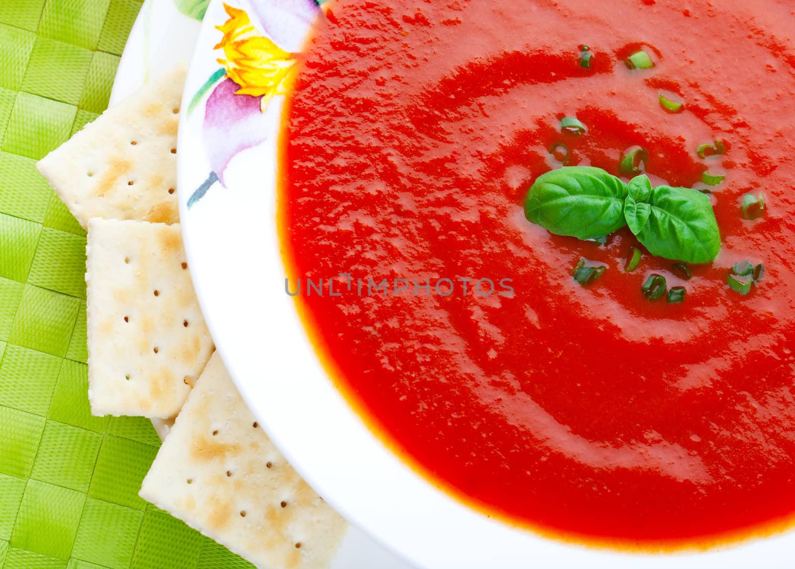 Thick and hearty tomato soup, made from fresh tomatoes and garnished with chives and a sprig of fresh basil.  Served with lightly salted crackers.