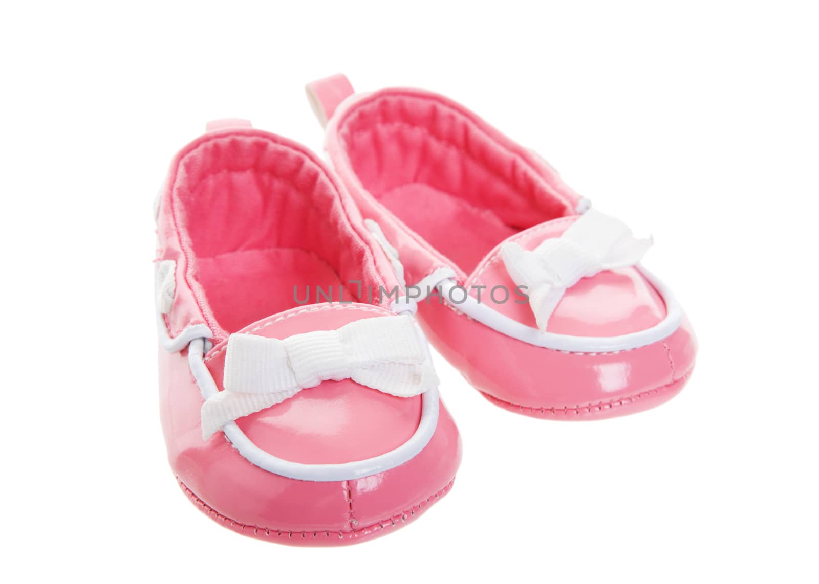 A pink pair of worn baby shoes.  Shot on white background.