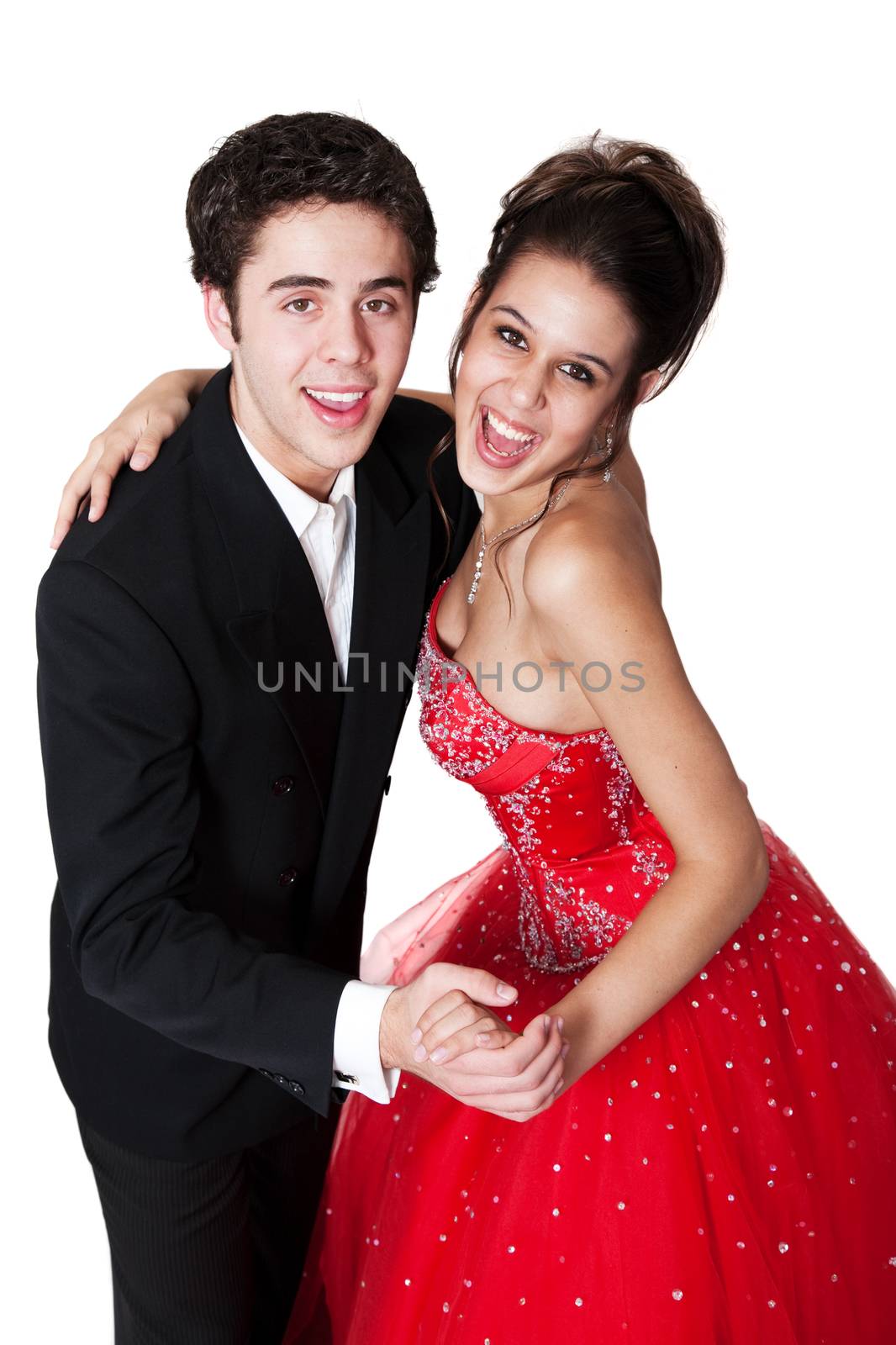 Boy and girl, in formal attire, dancing at their high school prom.