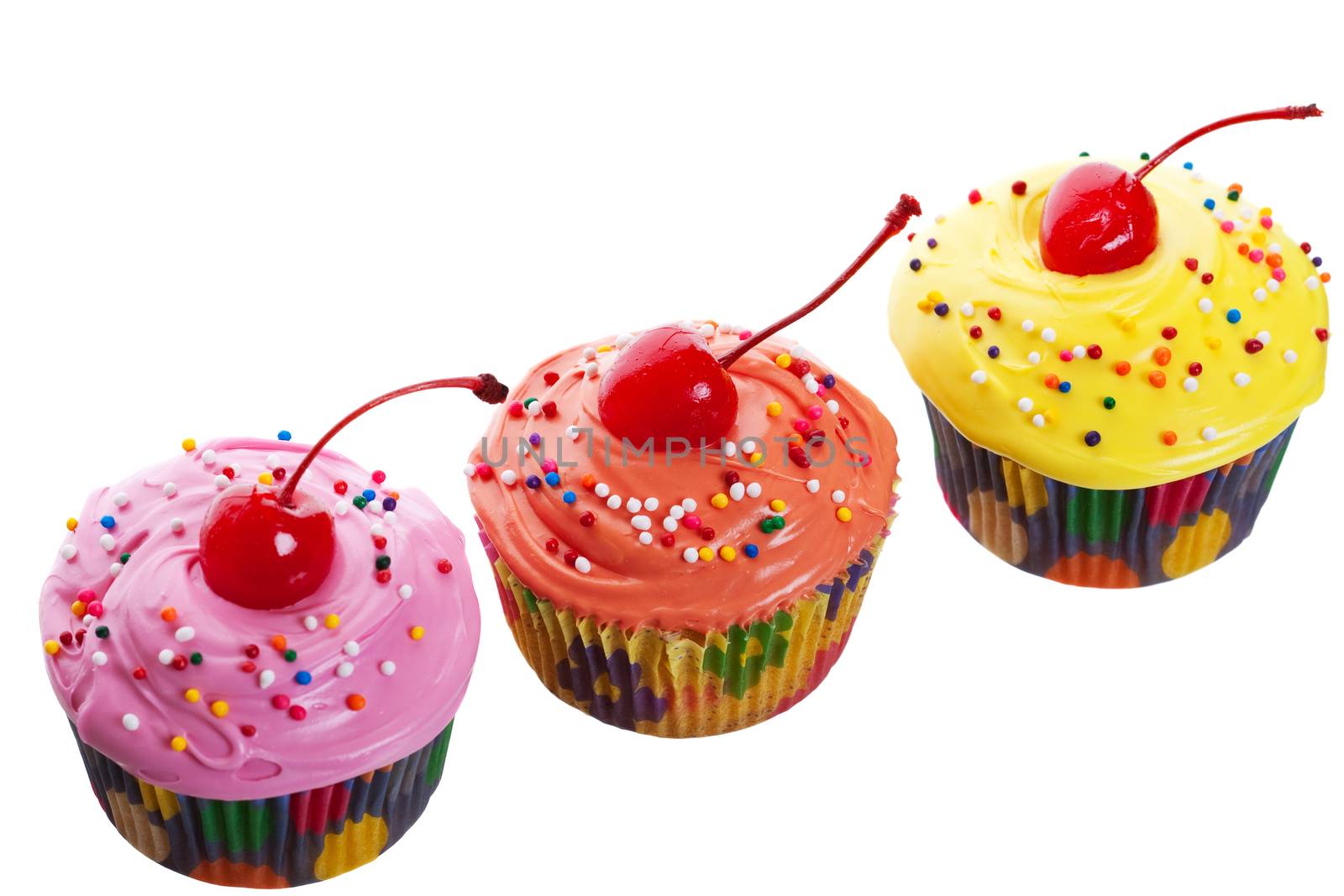 Three colorful, mouth-watering cherry cupcakes.  Shot on white background.
