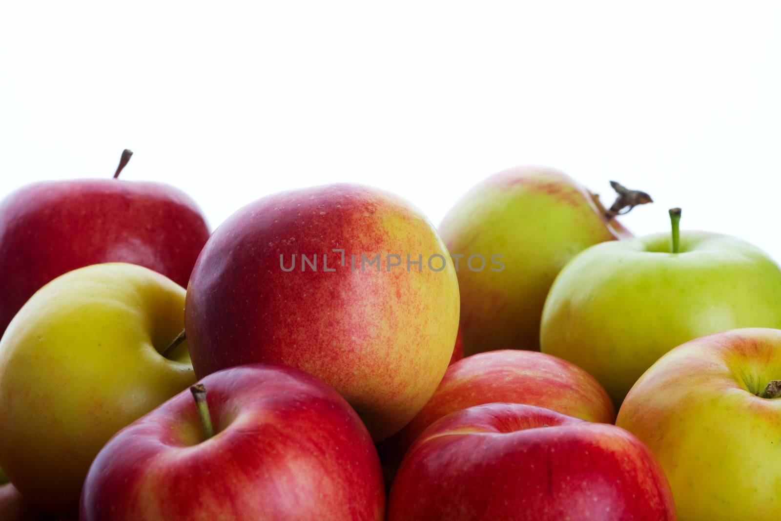 A bunch of fresh picked orchard apples.  Shot on white background.