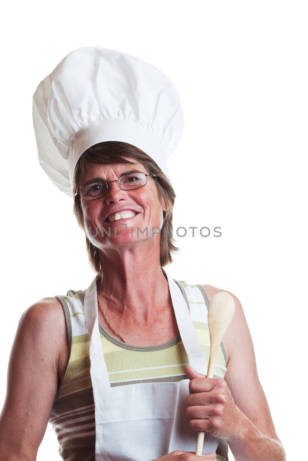 A mature, happy cook holding a wooden spoon.  Shot on white background.