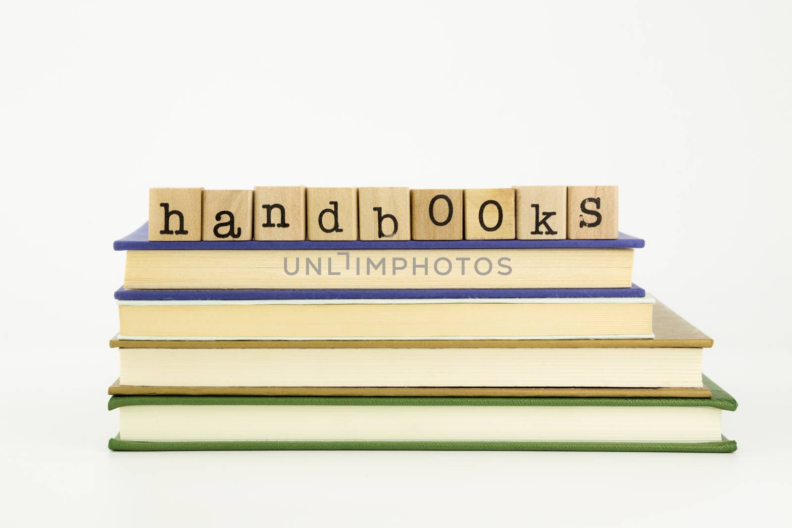handbooks word on wood stamps stack on books, homework and academic concept