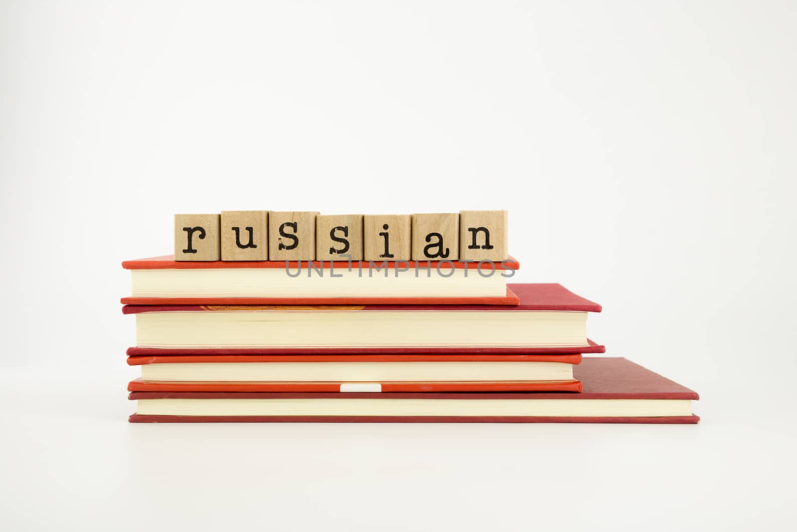russian word on wood stamps stack on books, language and academic concept